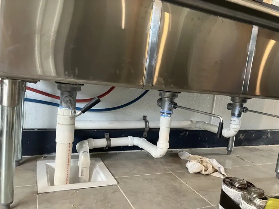 Commercial stainless sink with new PVC drain plumbing
